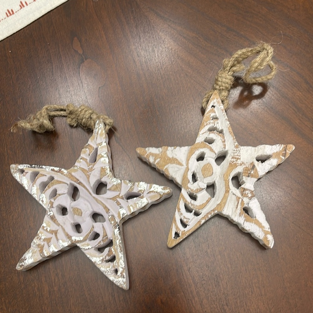 Two hand carved star ornaments